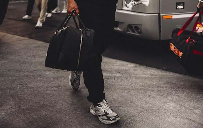 View of Caleb Williams' grey Asics sneakers before a USC Trojans game.